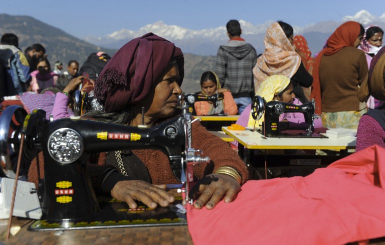 Indian widows, who lost their husbands during massive floods in the northern Indian states last June, take part in vocational training at Deoli-Bhanigram village in India's northern Uttarakhand state.©AFP